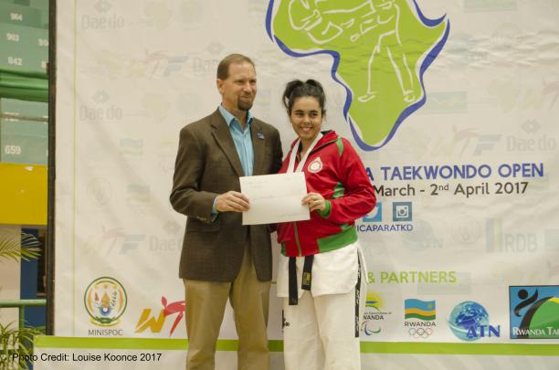Morocco's Rajae Akermach - taekwondo Woman holds sign with a man