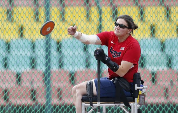 Rachael Morrison - USA Woman sits in chair and throws discus