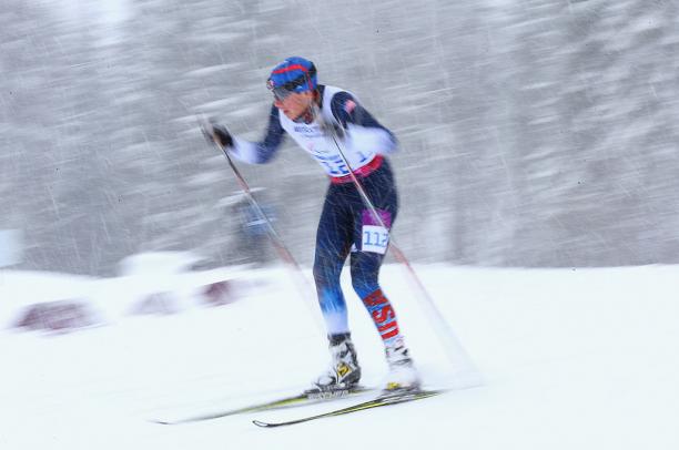 Jacob Adicoff a man uses skies and poles to get across the snow