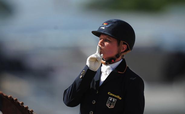 Hannelore Brenner A female rider puts her finger to her lips