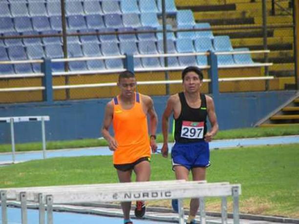 Oscar Raxon a Para athlete and his guide race on a track