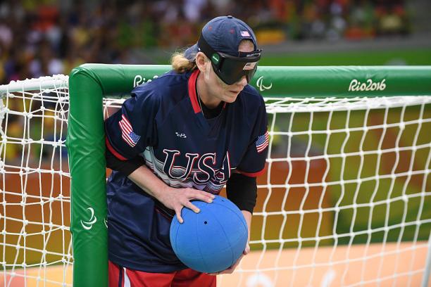 Jen Armbruster a female goalball player stands by the goal