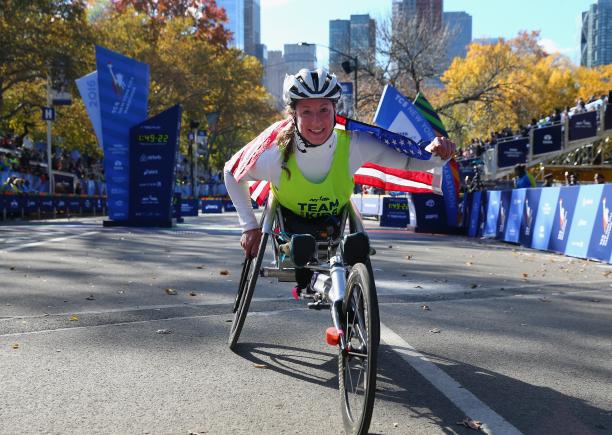Tatyana McFadden - New York 2016 a female Para wheelchair racer celebrates with an American flag
