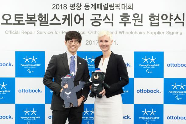 PyeongChang 2018 and Ottobock a man and a woman standing holding mascots
