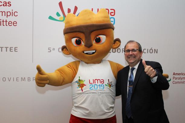 A cuddly mascot and a man give a thumbs up to the camera