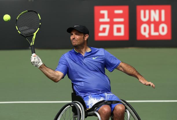 David Wagner a male wheelchair tennis player hits a forehand