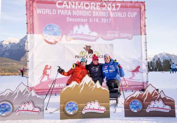 Women's sit ski podium 2017 World Para Nordic Skiing World Cup, Canmore, Canada Podium shot of Andrea Eskau, Marta Zainullina and Birgit Skarstein embracing.