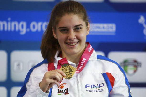 Monica Boggioni - Mexico City 2017 a female Para swimmer holds up her gold medal and smiles