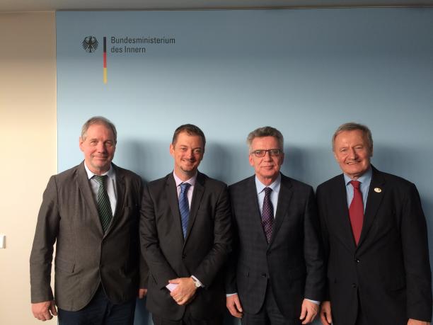 Andrew Parsons and German government a group of four men standing and smiling