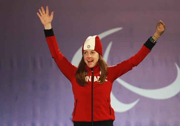 Lauren Woolstencroft - Vancouver 2010 a female Para skier raises her arms in celebration on the podium