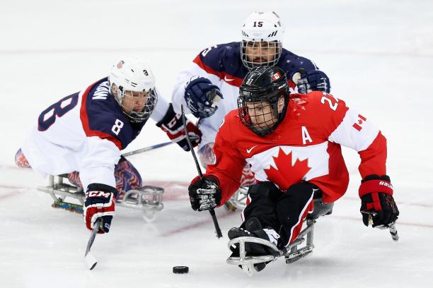 Canada v USA - Sochi 2014 ice hockey three male Para ice hockey players clash on the ice