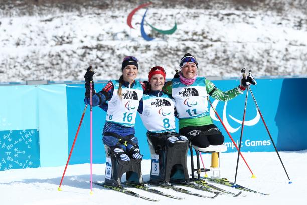 PyeongChang 2018 women's sitting 6km biathlon three female Nordic skiers hugging