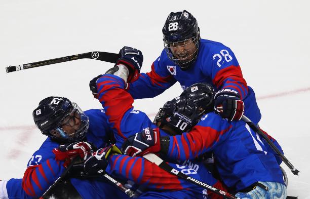 South Korea beat Japan - PyeongChang 2018 a Para ice hockey team hug in celebration