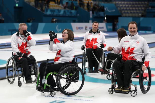 Canada wheelchair curling - PyeongChang 2018 a wheelchair curling team celebrates on the ice