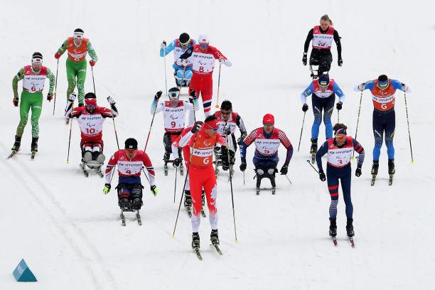 a group of cross-country skiers sprint for the finish line