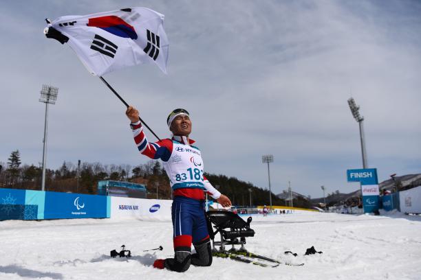 Eui Hyun Sin - PyeongChang 2018 a male Para Nordic skier celebrates with the South Korean flag