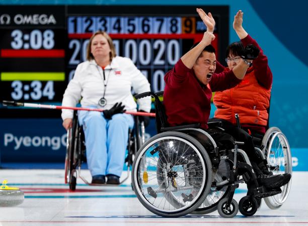 China win wheelchair curling gold - PyeongChang 2018 wheelchair curlers celebrating on the ice