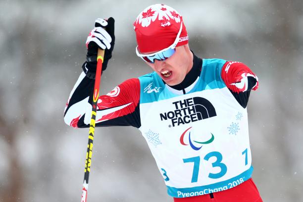 a male Para Nordic skier ploughs through the snow