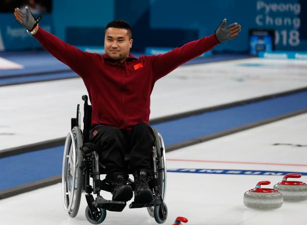 Haitao Wang - PyeongChang 2018 a male wheelchair curler raises his arms in celebration