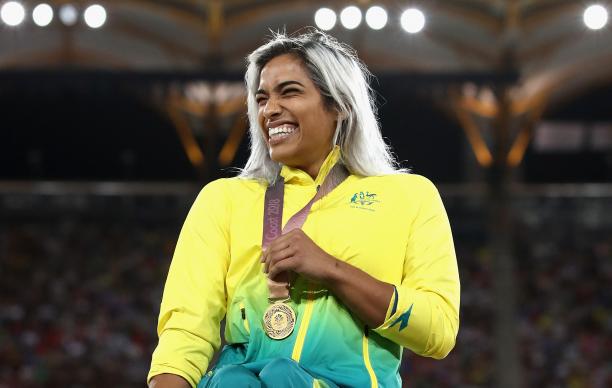 Madison de Rozario - Gold Coast 2018 a female wheelchair racer laughs with her gold medal