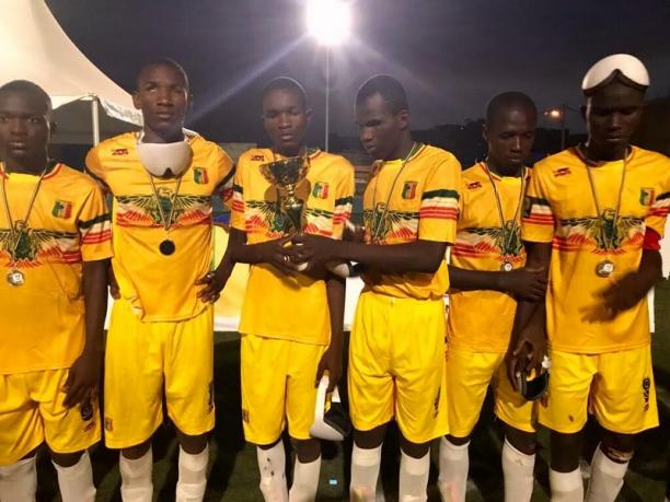 Mali blind football a group of blind footballers hold up a trophy