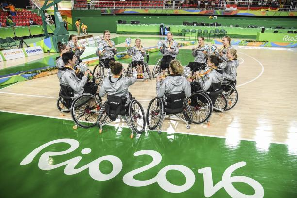 A group of female wheelchair basketballers in a circle