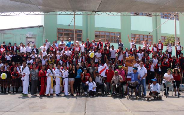 a group of Para athletes and schoolchildren
