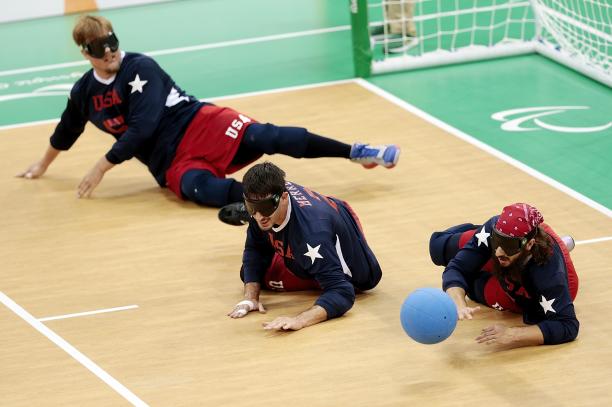 three goalball players in action
