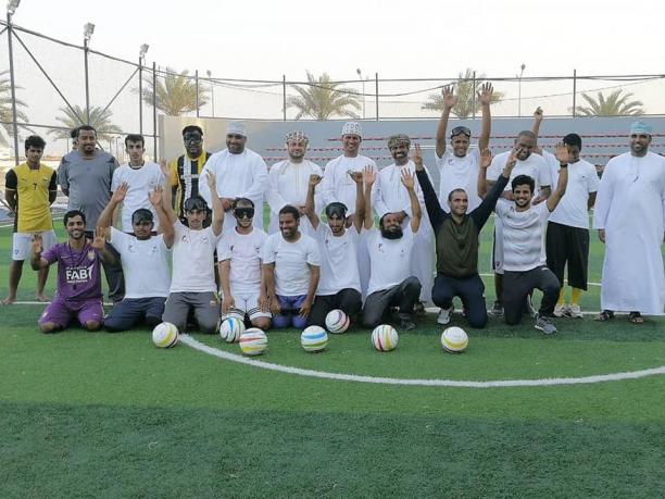 Oman blind football workshop a group of blind footballers line up on a pitch