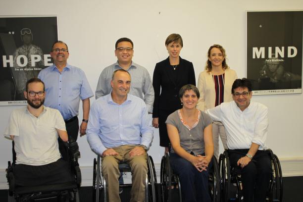 IPC governance review meeting - May 2018 A group of eight people both standing and sitting smile for the camera