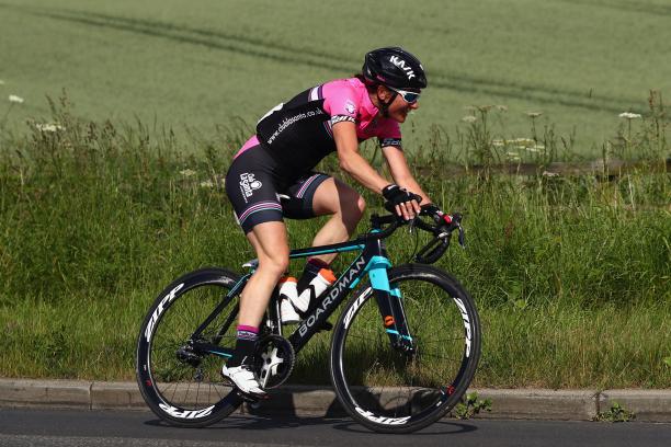 Sarah Storey a female Para cyclist rides down a road