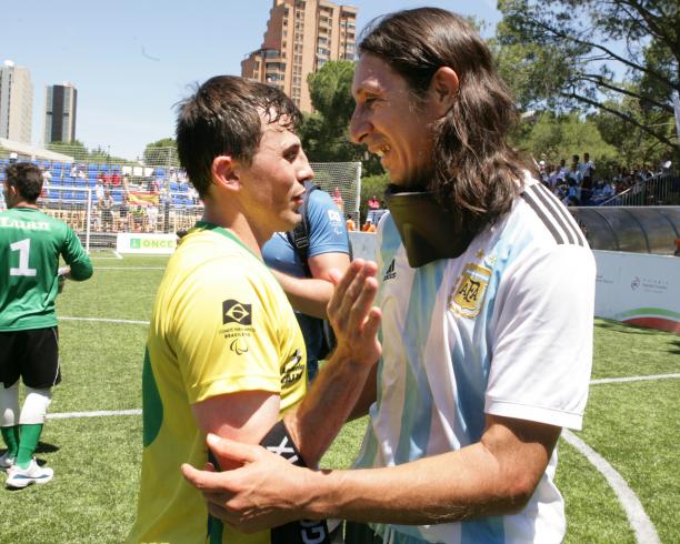Ricardinho and Froilan Padilla two blind footballers hugging on the pitch