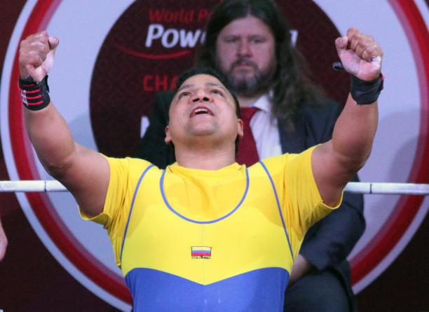Jainer Cantillo - Mexico City 2017 a male powerlifter raises his arms in celebration on the bench