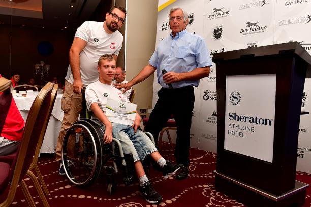 Juliusz Trochimczuk - Poland - swimming Polish male swimmer Juliusz Trochimczuk in a wheelchair receives an award from two men