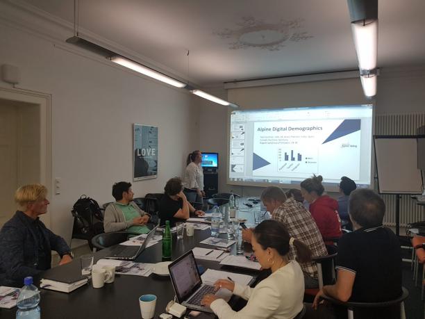 World Para Alpine Skiing organisers meeting at IPC headquarters in Bonn A group of people sitting watching a presentation on a screen