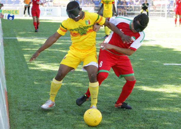 Mali vs Iran - blind football Two blind football players battle for the ball