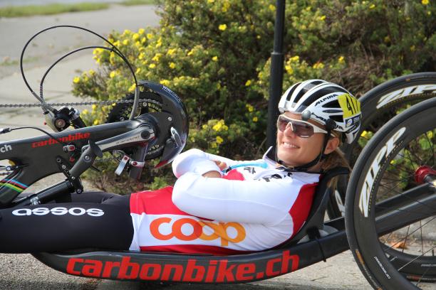 female Para cyclist Ursula Schwaller using a hand bike on the road