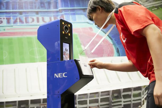 Tokyo 2020 face recognition system a person looks into a camera while displaying their accreditation in a simulation of the Tokyo 2020 system