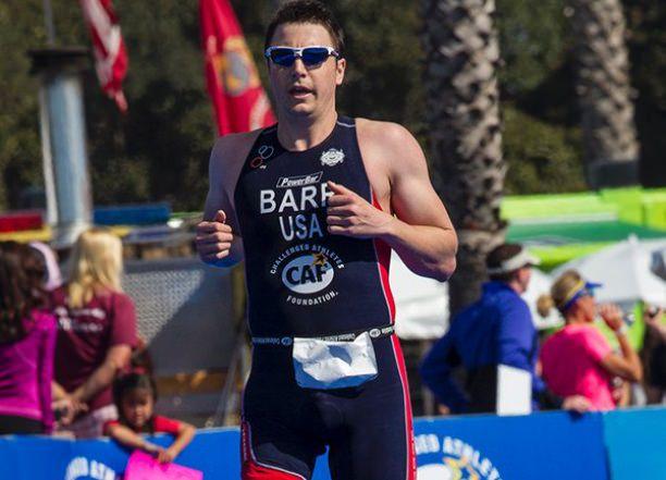 Mark Barr A picture of a man with one prosthesis running and crossing a finish line