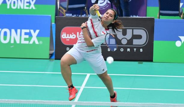 Leani Ratri Oktila - Indonesia - badminton Female badminton player jumps to hit a birdie