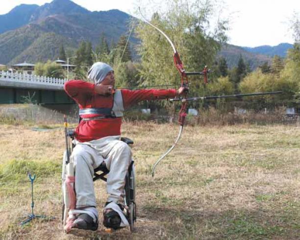 Pema Rigsel - Bhutan male Para archer Pema Rigsel prepares to shoot an arrow