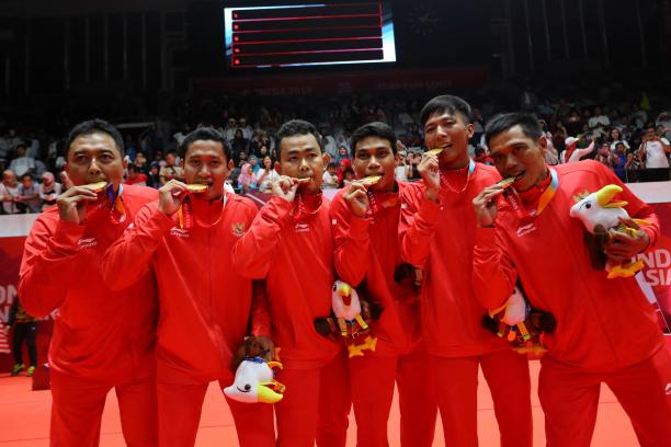 Indonesia men's badminton team - Indonesia 2018 a group of Indonesian male Para badminton players biting their gold medals