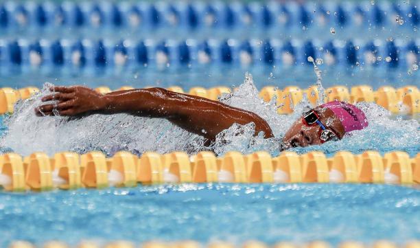 female Para swimmer Indriani Syuci in the pool completing a freestyle stroke