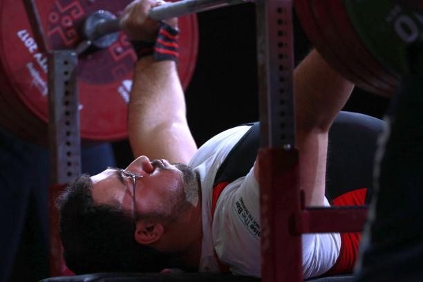 Roohallah Rostami male powerlifter Roohallah Rostami gets ready to lift the bar