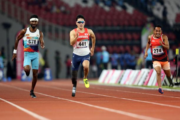 Shunsuke Itani - Indonesia 2018 three male sprinters with Shunsuke Itani in the centre run down the 100m track