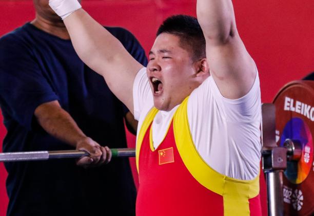 male powerlifter Jixiong Ye raises his arms in celebration