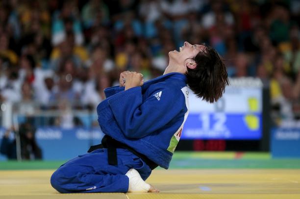 Sandrine Martinet - Rio 2016 female judoka Sandrine Martinet sinks to her knees and clenches her fists after winning
