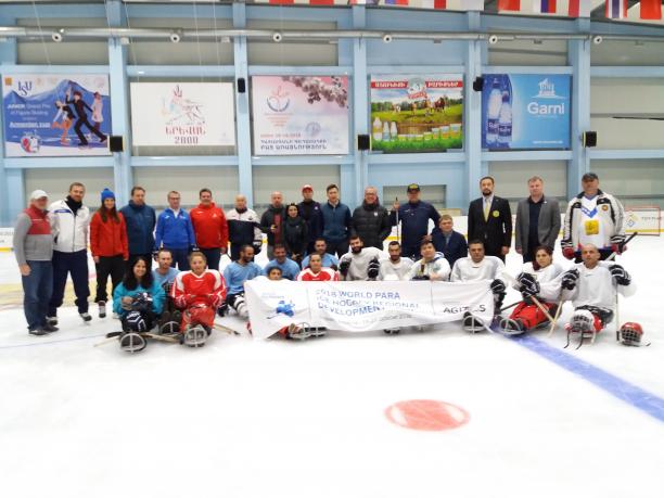 Para Ice Hockey Development Camp Armenia A group of people on sledges on an ice hockey rink