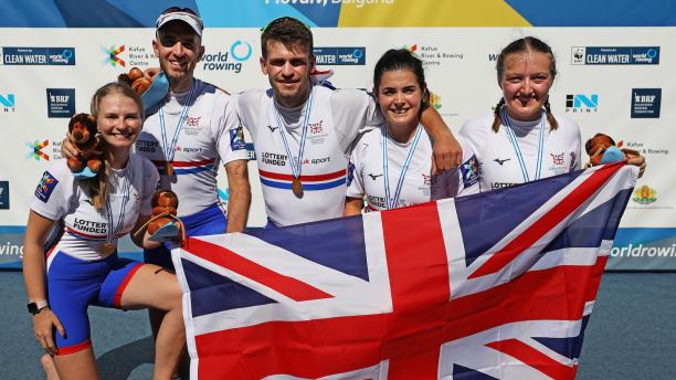 Great Britain PR3 mixed coxed four - Plovdiv 2018 five Para rowers with Ellen Buttrick on the right holding up a Great Britain flag