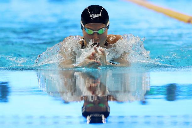 Amilova Fotimakhon - Indonesia 2018 female Para swimmer Amilova Fatimakhon takes a breath during a breaststroke